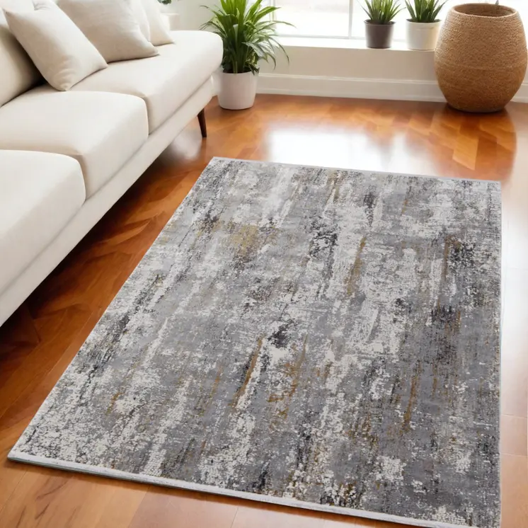 5' X 8' Gray Ivory and Gold Abstract Power Loom Area Rug With Fringe