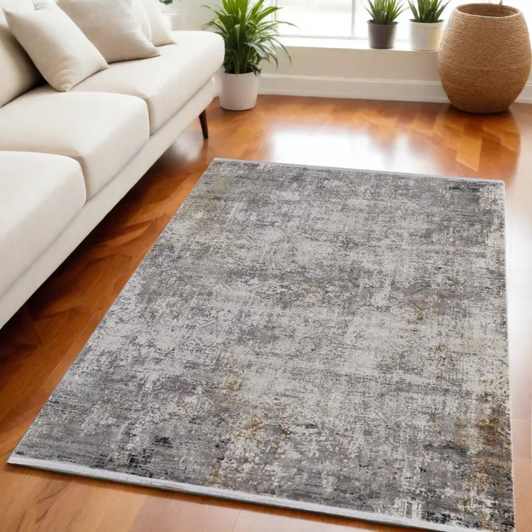 5' X 8' Ivory Taupe and Gray Abstract Power Loom Distressed Area Rug With Fringe