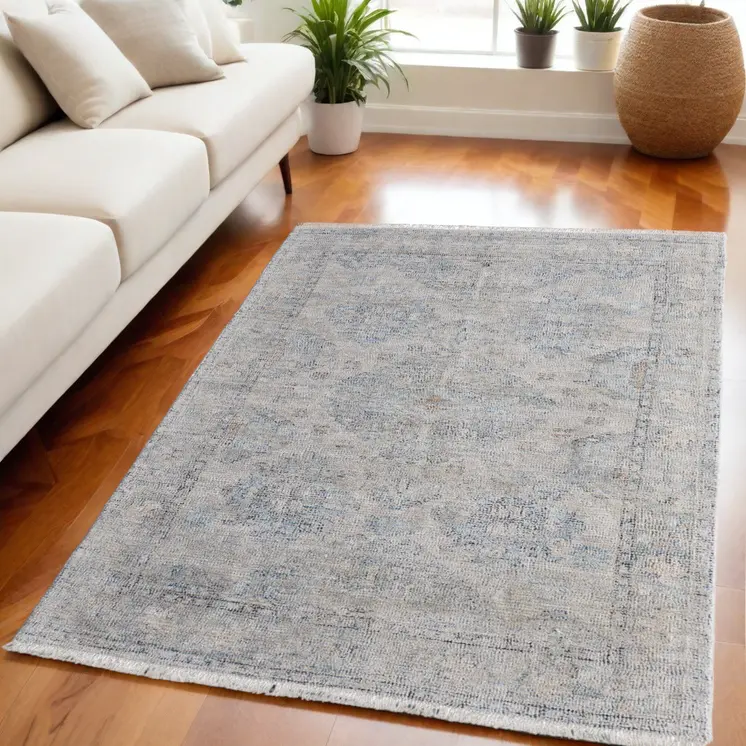 5' X 8' Gray Blue and Taupe Oriental Hand Woven Distressed Area Rug With Fringe