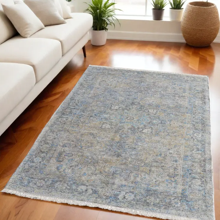 5' X 8' Gray Blue and Tan Abstract Hand Woven Distressed Area Rug With Fringe