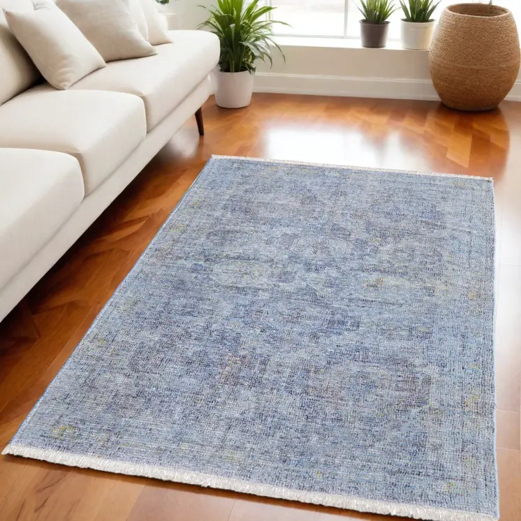 5' X 8' Blue and Ivory Abstract Hand Woven Distressed Area Rug With Fringe