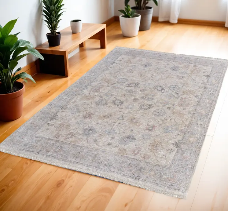 4' X 6' Ivory Tan and Blue Floral Hand Woven Distressed Area Rug With Fringe