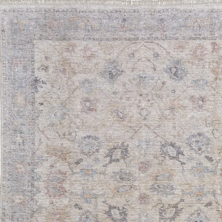 5' X 8' Ivory Tan and Blue Floral Hand Woven Distressed Area Rug With Fringe