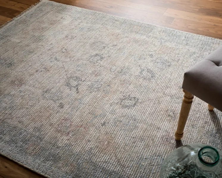 5' X 8' Ivory Tan and Blue Floral Hand Woven Distressed Area Rug With Fringe