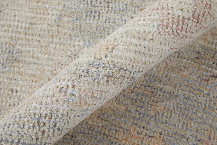 8' X 10' Ivory Tan and Blue Floral Hand Woven Distressed Area Rug With Fringe