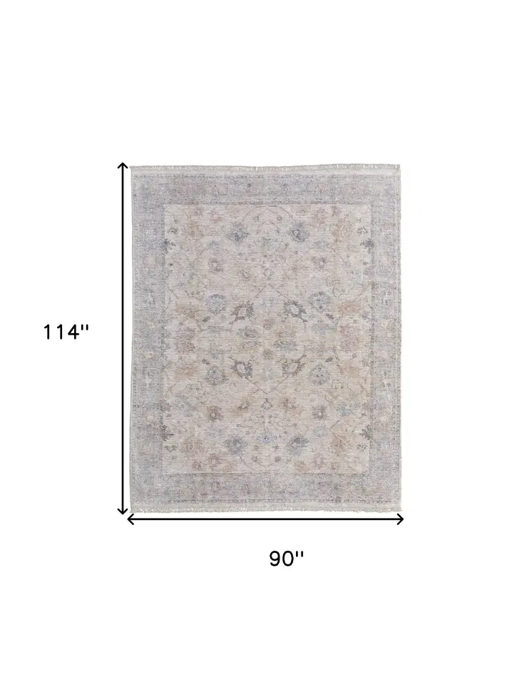 8' X 10' Ivory Tan and Blue Floral Hand Woven Distressed Area Rug With Fringe