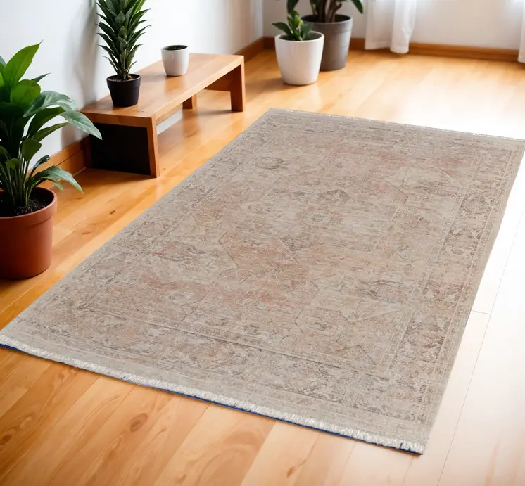4' X 6' Tan Orange and Ivory Oriental Hand Woven Distressed Area Rug With Fringe