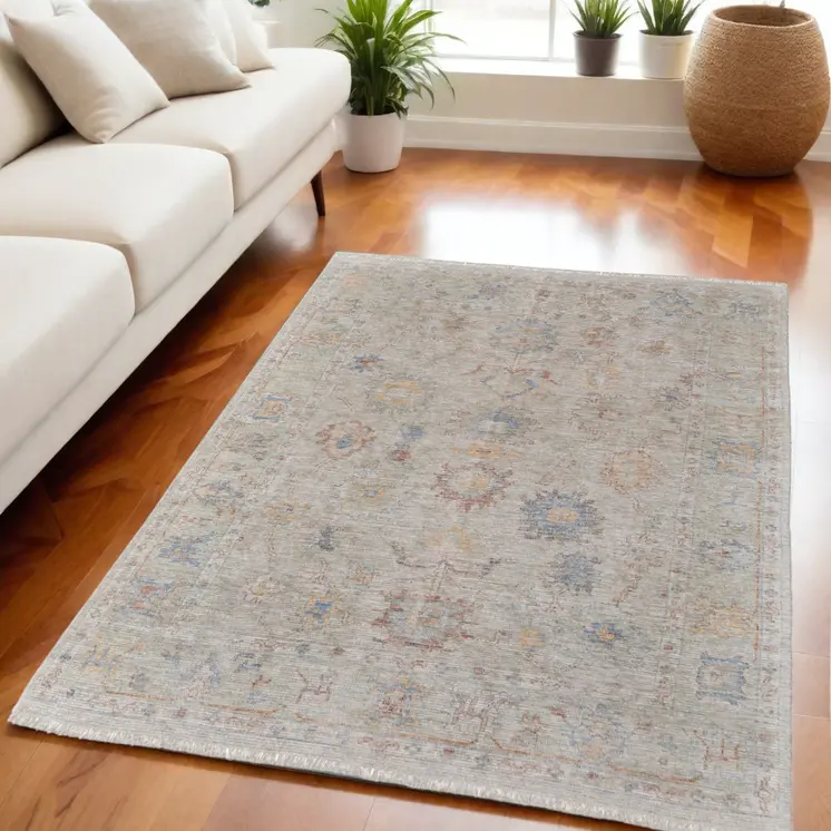 5' X 8' Tan Brown and Blue Floral Hand Woven Distressed Area Rug With Fringe
