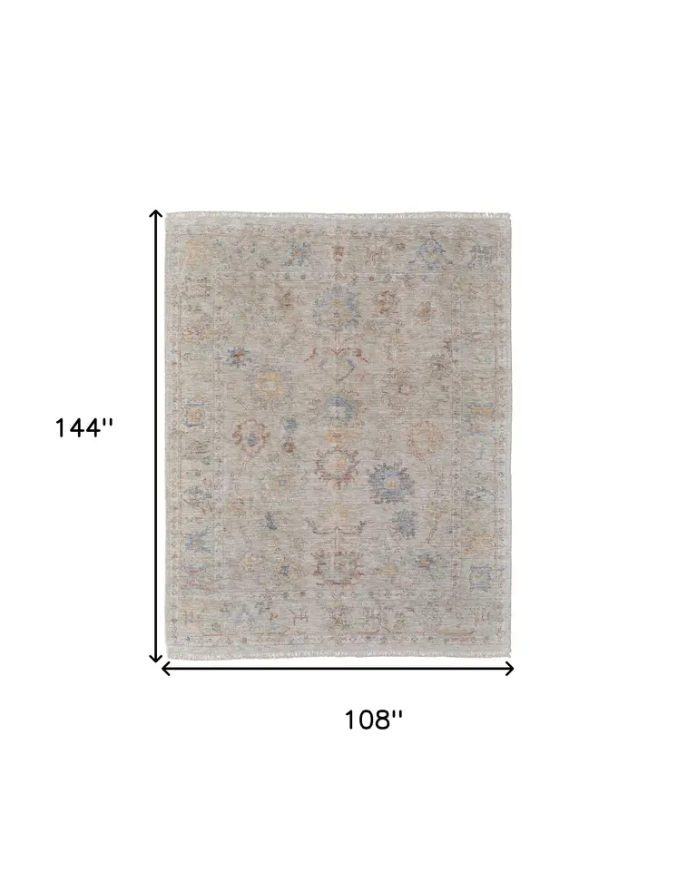 9' X 12' Tan Brown and Blue Floral Hand Woven Distressed Area Rug With Fringe
