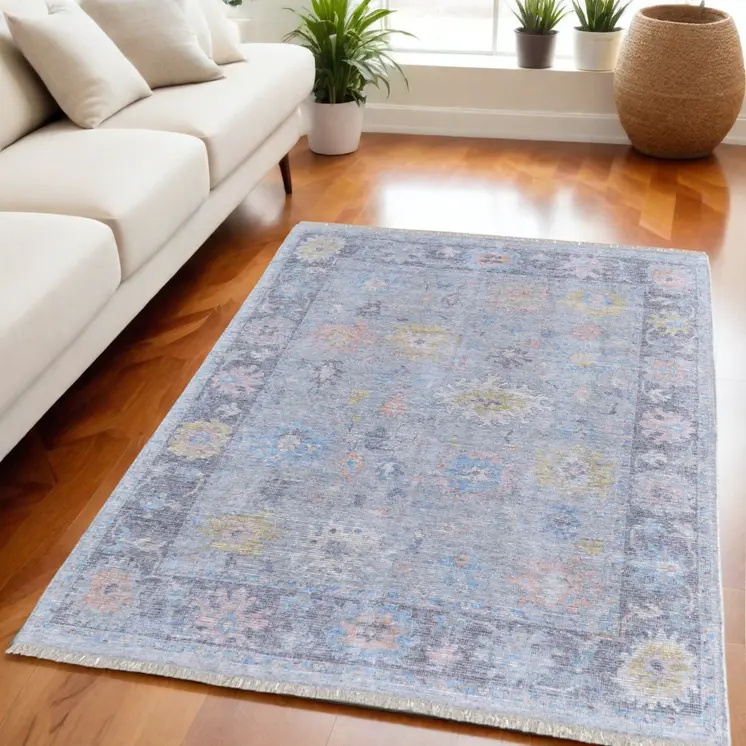 5' X 8' Orange Blue and Gold Floral Hand Woven Distressed Area Rug With Fringe