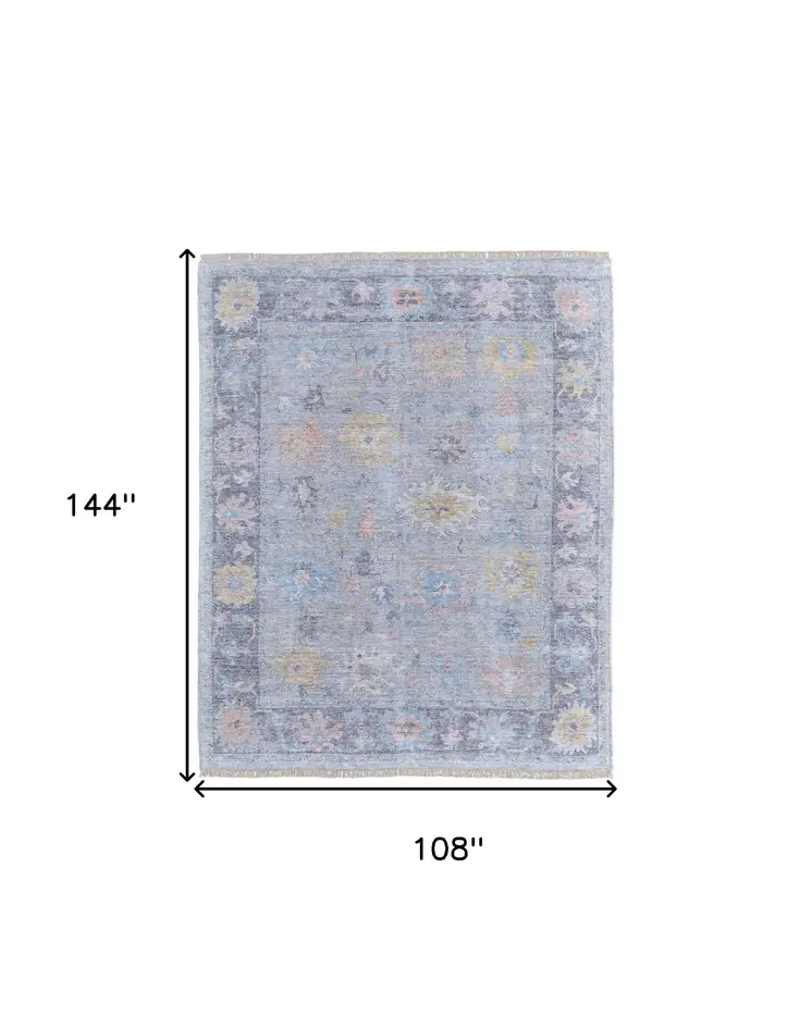 9' X 12' Orange Blue and Gold Floral Hand Woven Distressed Area Rug With Fringe