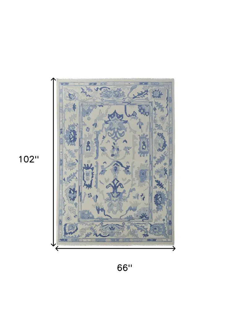 6' X 9' Ivory and Blue Wool Floral Hand Knotted Area Rug With Fringe