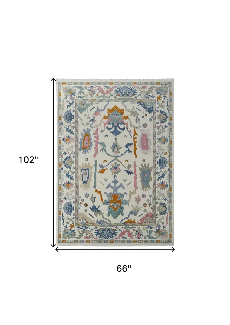 6' X 9' Blue Ivory and Pink Wool Floral Hand Knotted Area Rug With Fringe