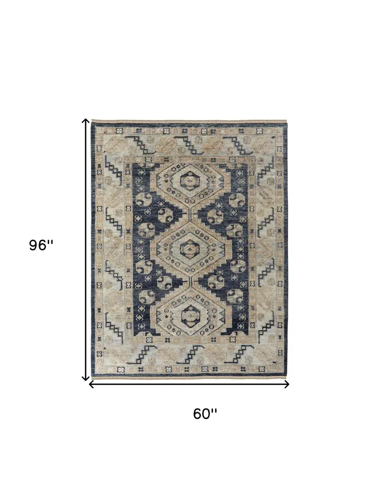 5' X 8' Blue and Ivory Wool Geometric Hand Knotted Area Rug With Fringe