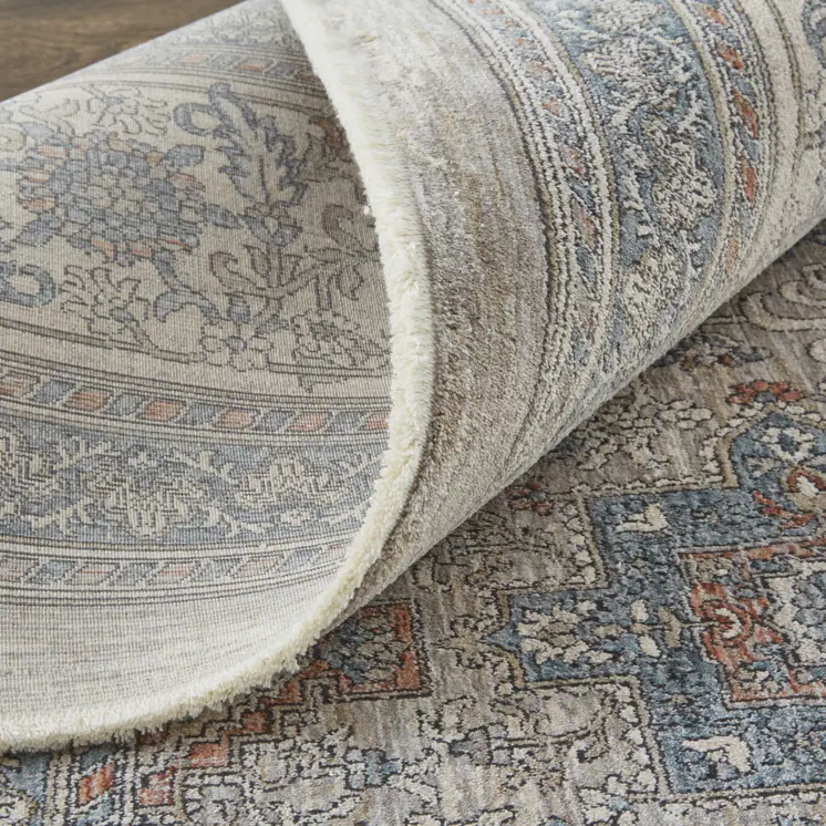7' X 10' Silver Taupe and Blue Oriental Power Loom Worn Faded Area Rug With Fringe