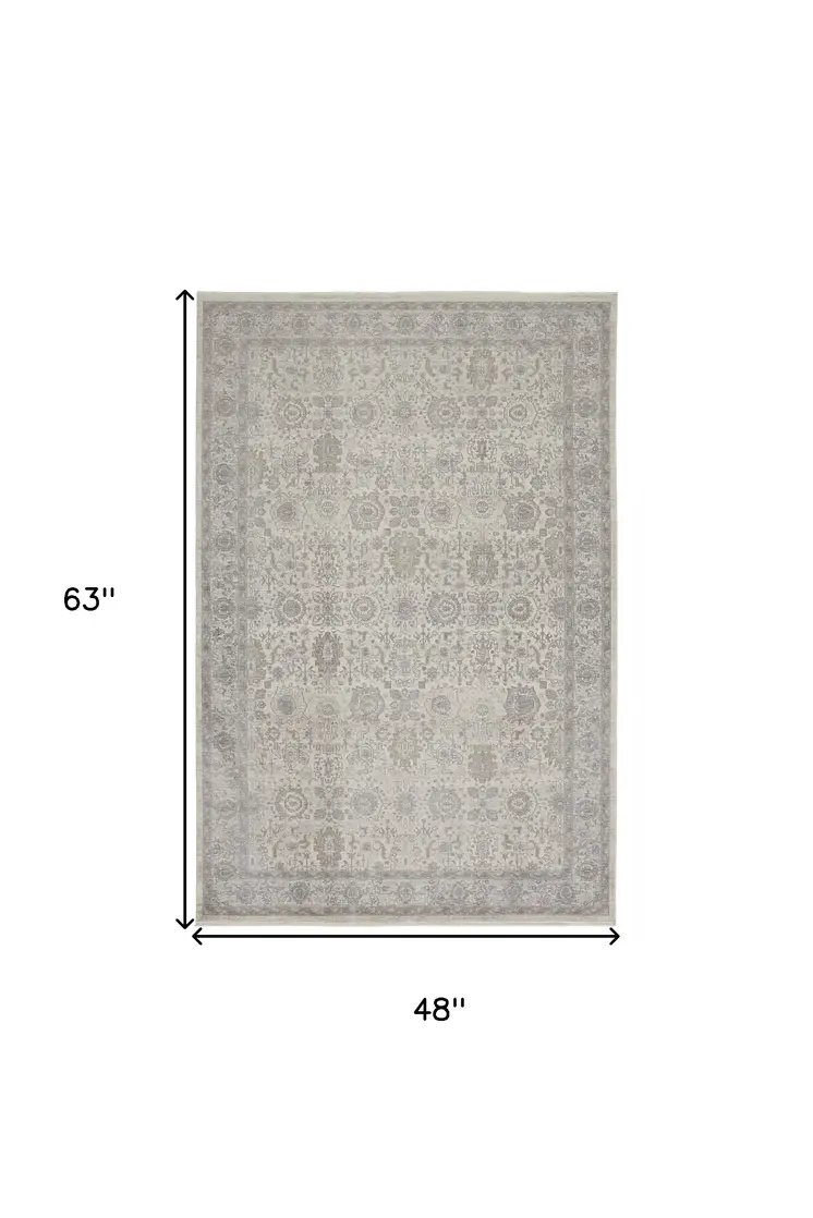 4' X 5' Gray and Ivory Oriental Power Loom Worn Faded Area Rug With Fringe