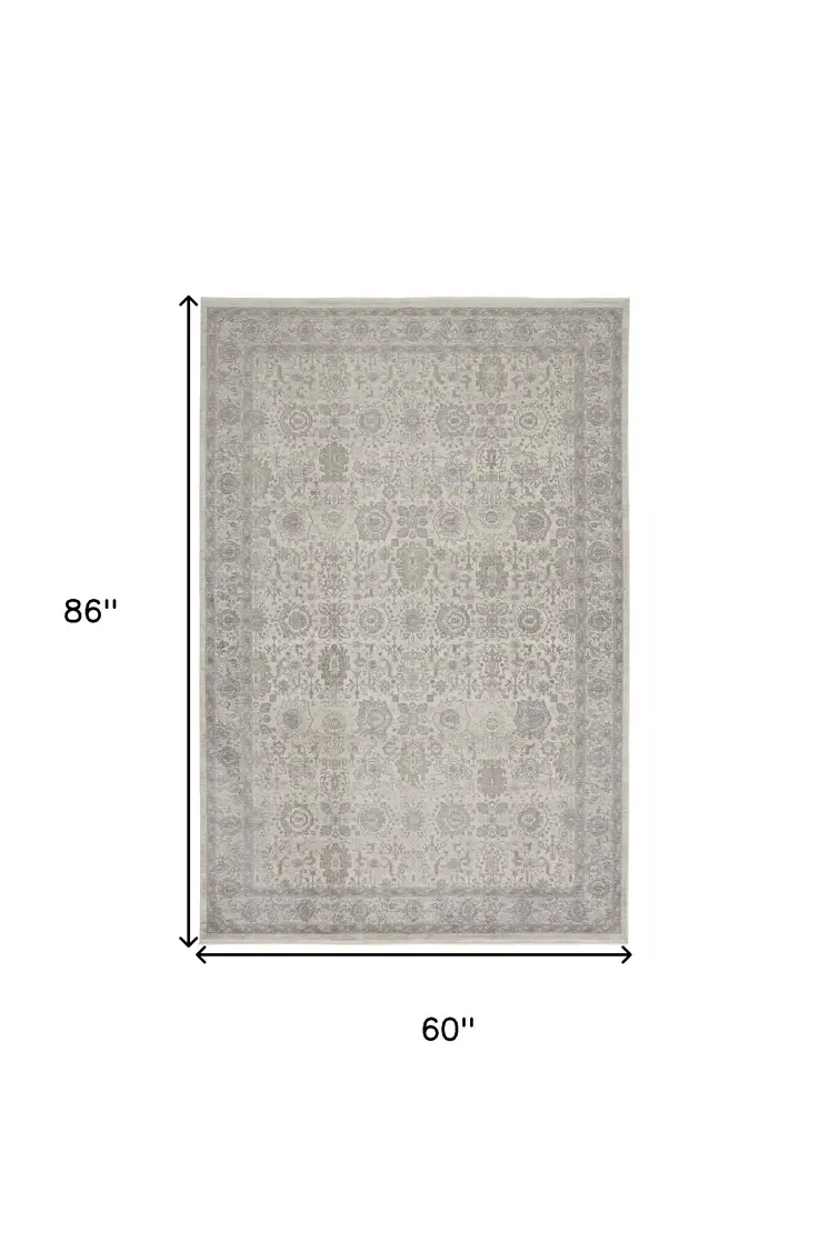 5' X 7' Gray and Ivory Oriental Power Loom Worn Faded Area Rug With Fringe