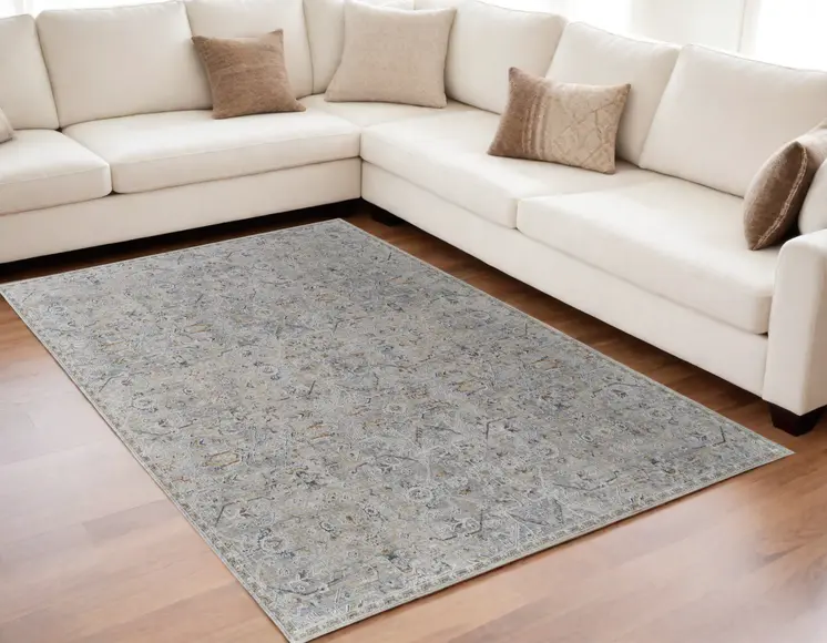 5' X 8' Ivory Tan and Blue Abstract Power Loom Worn Faded Area Rug With Fringe