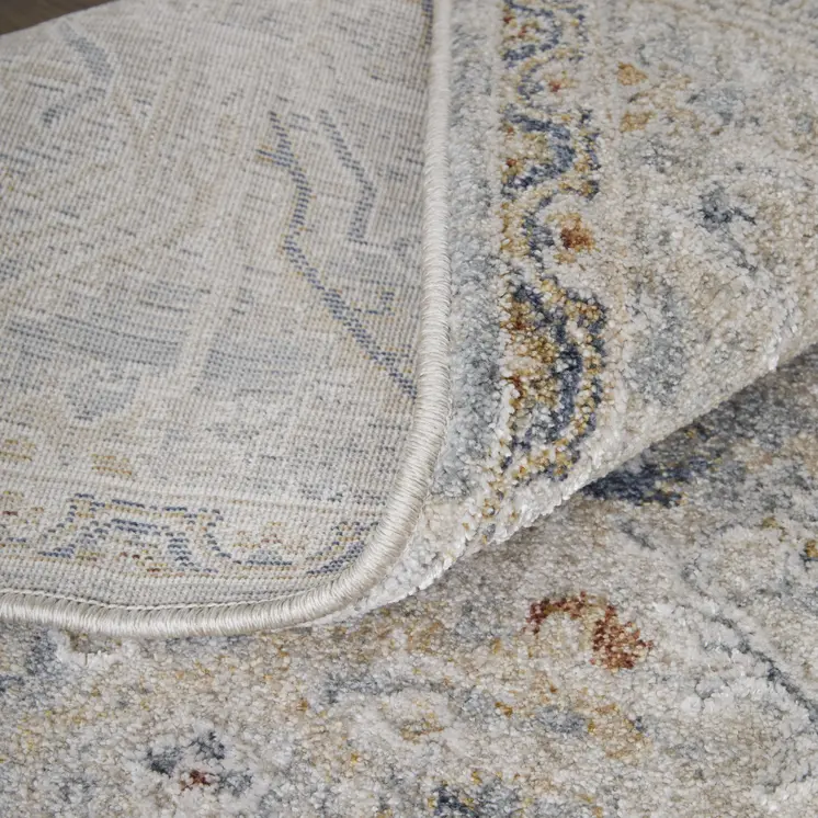 9' X 13' Ivory Tan and Blue Abstract Power Loom Worn Faded Area Rug With Fringe