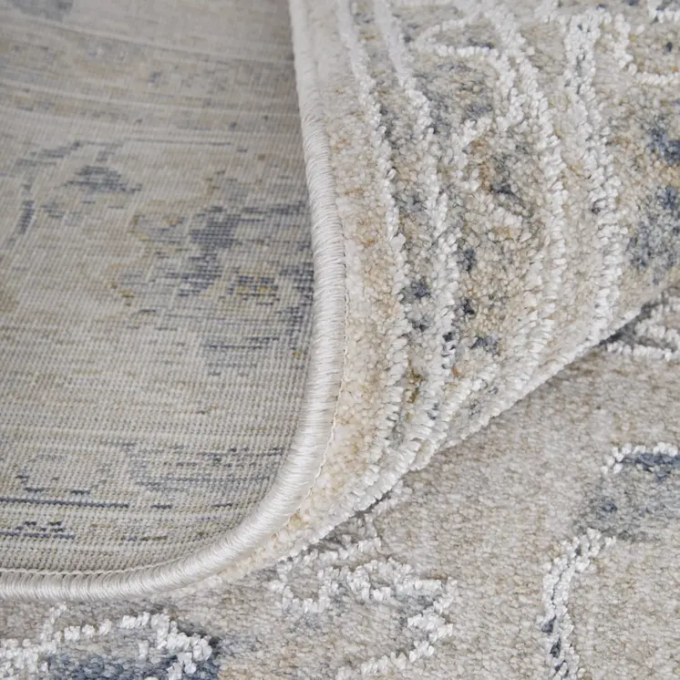 7' X 10' Ivory Taupe and Blue Floral Power Loom Worn Faded Area Rug With Fringe