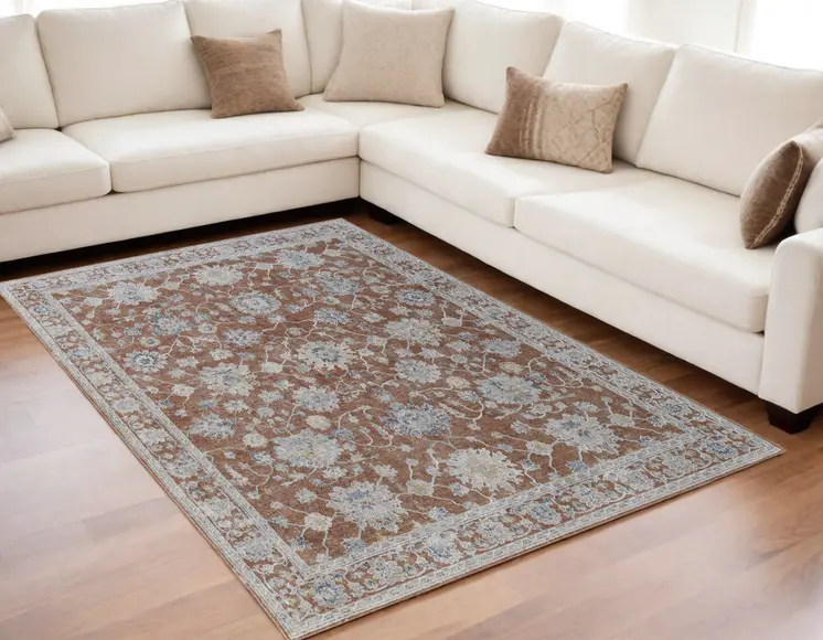 5' X 8' Red Blue and Ivory Floral Power Loom Worn Faded Area Rug With Fringe