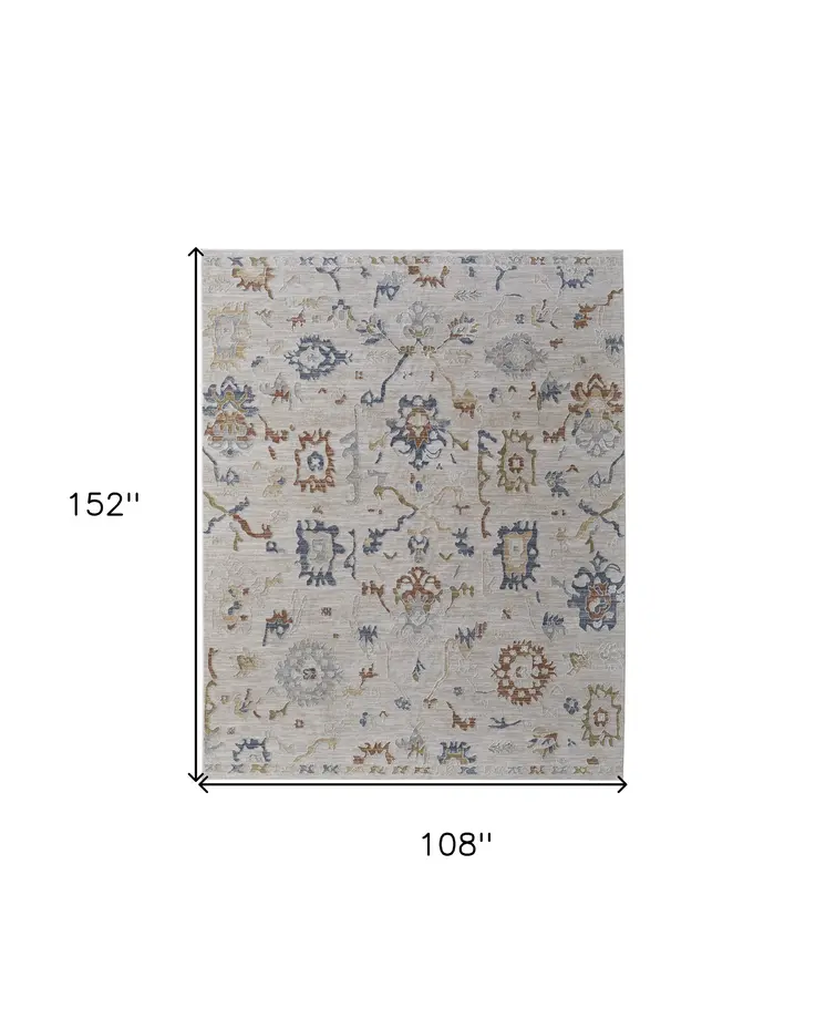9' X 13' Ivory Blue and Gold Floral Power Loom Worn Faded Area Rug With Fringe