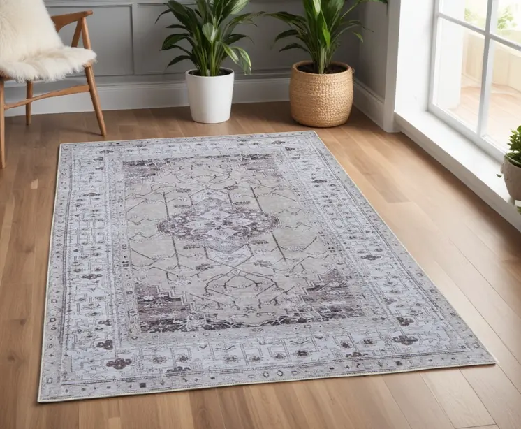 4' X 6' Gray Tan and Ivory Oriental Power Loom Worn Faded Washable Area Rug