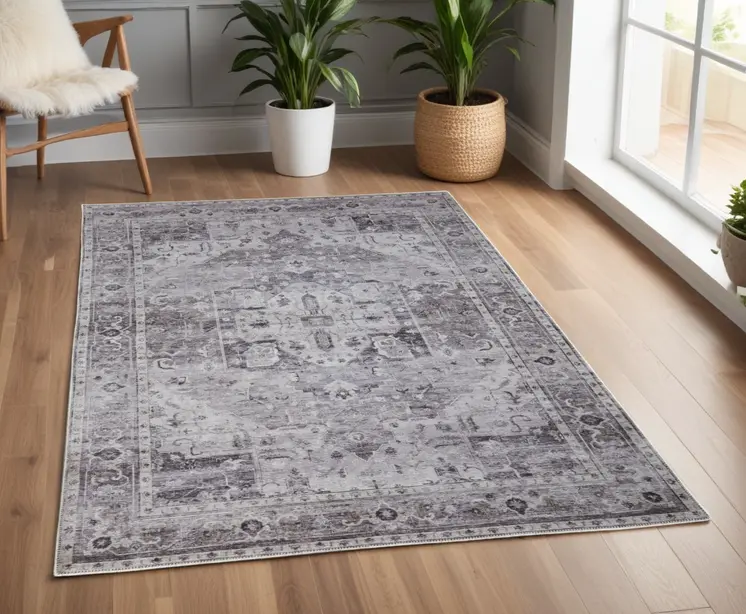 4' X 6' Gray and Ivory Oriental Power Loom Worn Faded Washable Area Rug