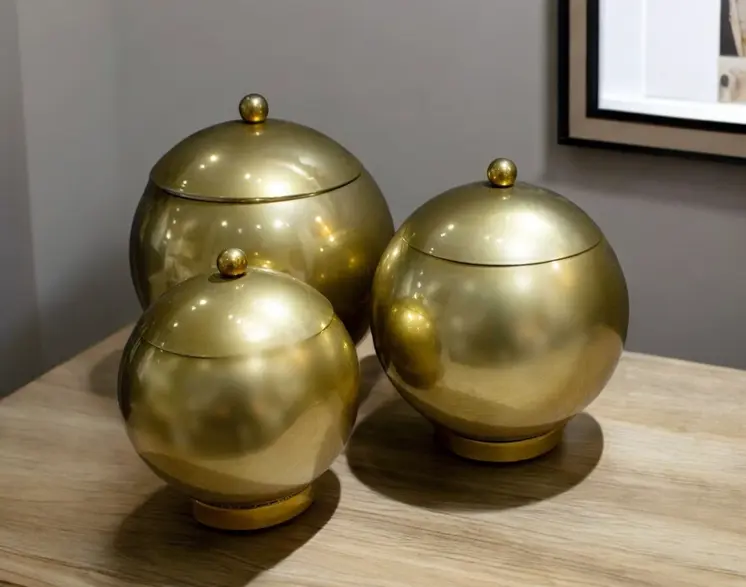 Set of Three Gold Metal Decorative Lidded Canisters