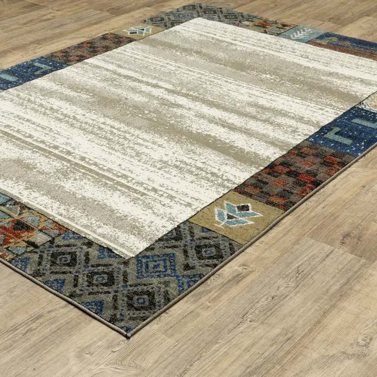 7' X 9' Ivory Tan And Blue Patchwork Area Rug
