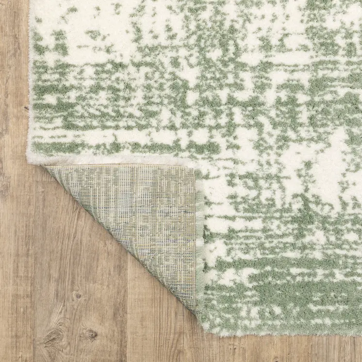 5' X 8' Green And Ivory Abstract Area Rug