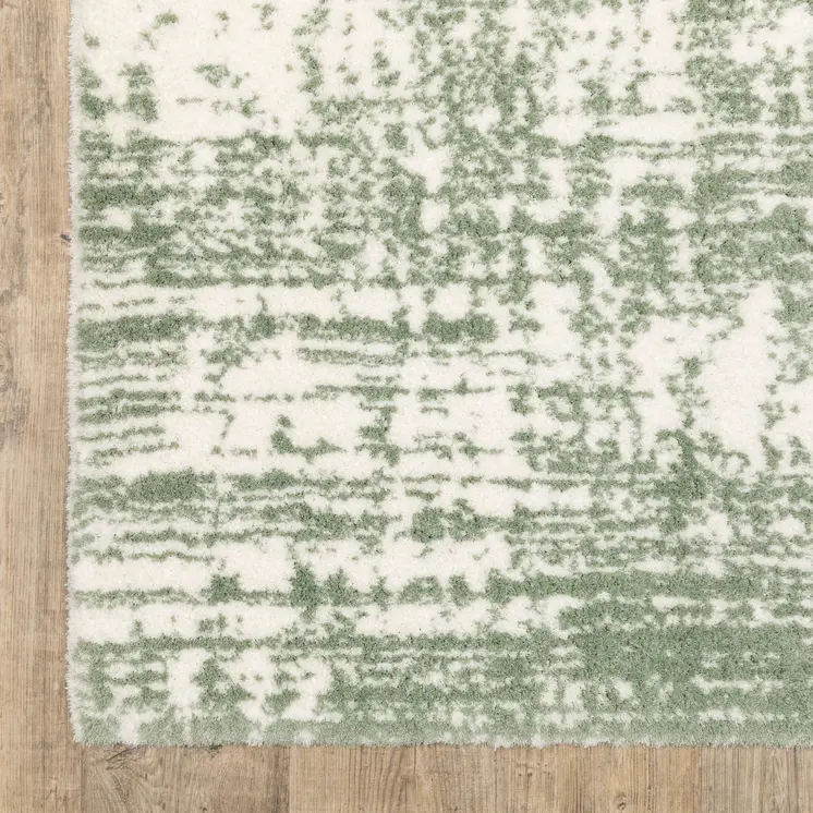 5' X 8' Green And Ivory Abstract Area Rug
