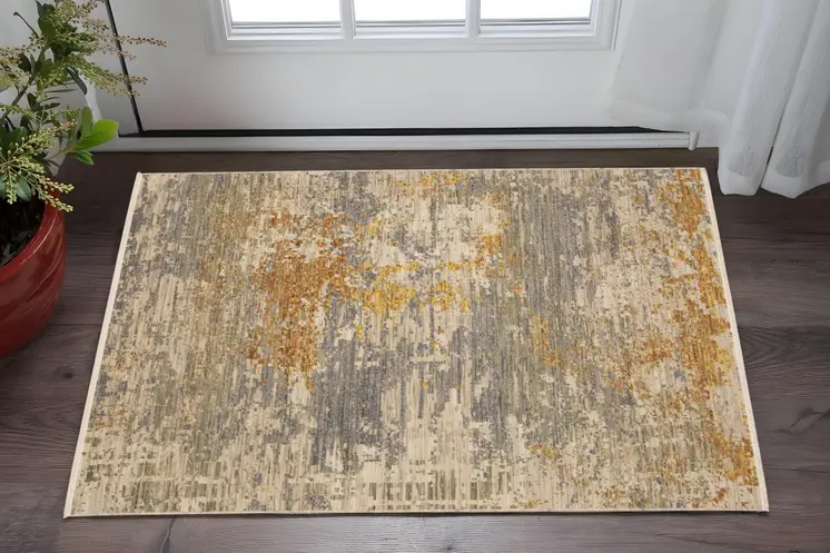 3' X 5' Beige And Gold Abstract Area Rug With Fringe