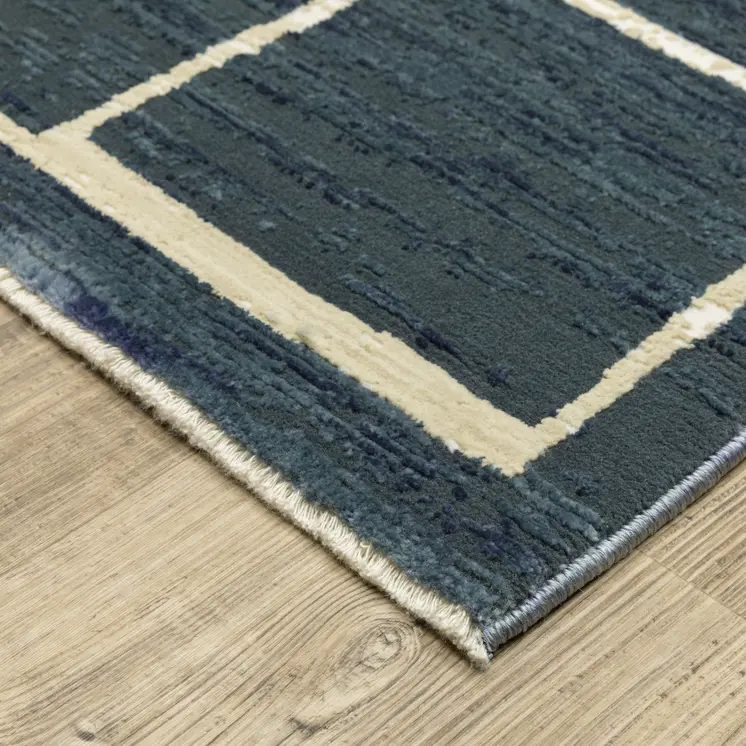5' X 8' Blue And Ivory Geometric Area Rug