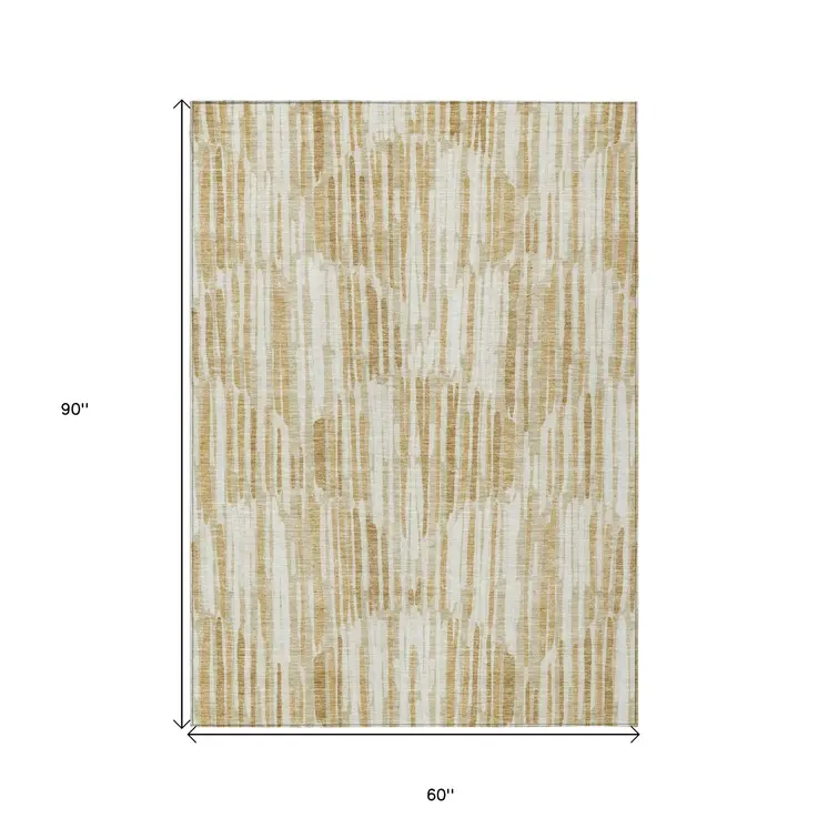 5' X 8' Gold Beige And Ivory Abstract Washable Indoor Outdoor Area Rug