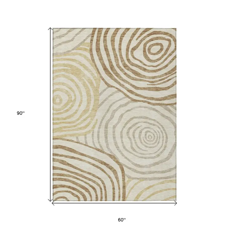 5' X 8' Gold Ivory And Beige Abstract Washable Indoor Outdoor Area Rug
