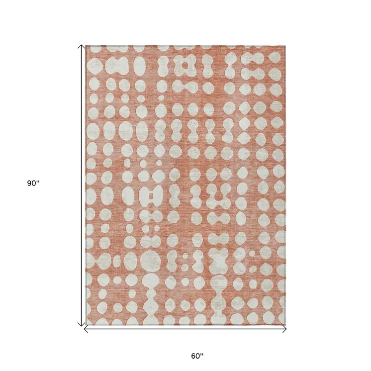 5' X 8' Salmon And Ivory Abstract Washable Indoor Outdoor Area Rug