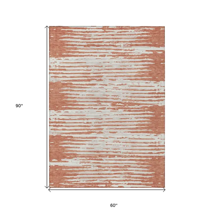 5' X 8' Coral And Ivory Striped Washable Indoor Outdoor Area Rug