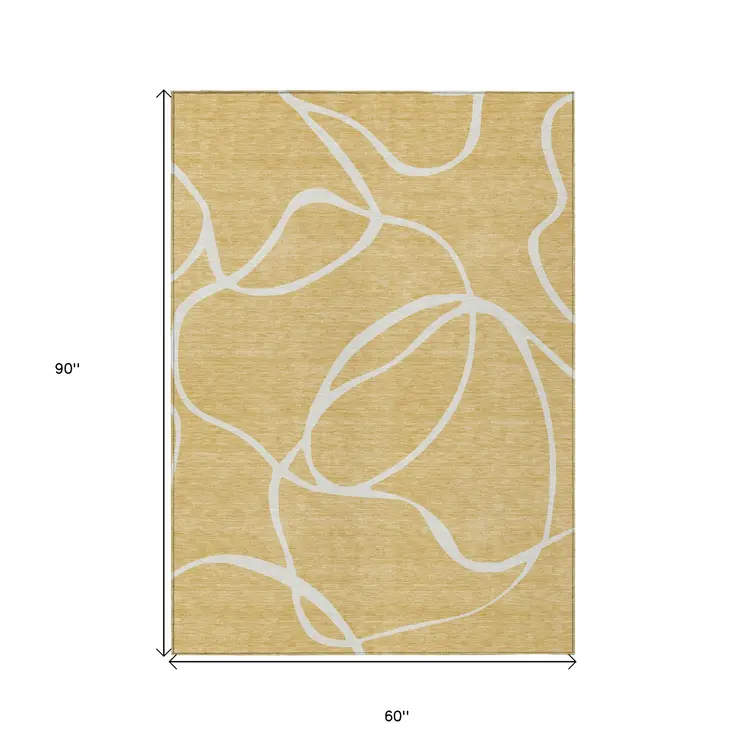 5' X 8' Gold And Ivory Abstract Washable Indoor Outdoor Area Rug