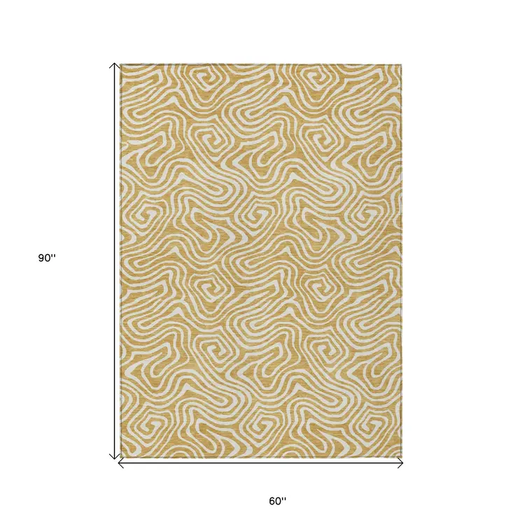5' X 8' Gold And Ivory Abstract Washable Indoor Outdoor Area Rug