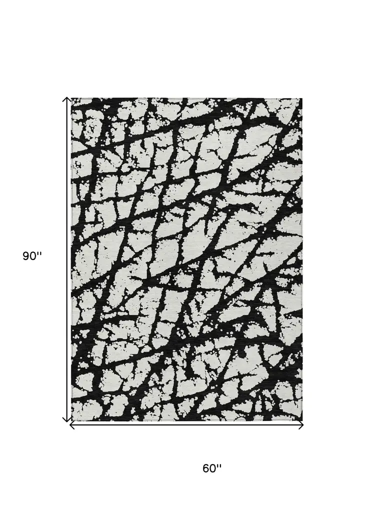 5' X 8' Black And Ivory Abstract Washable Indoor Outdoor Area Rug