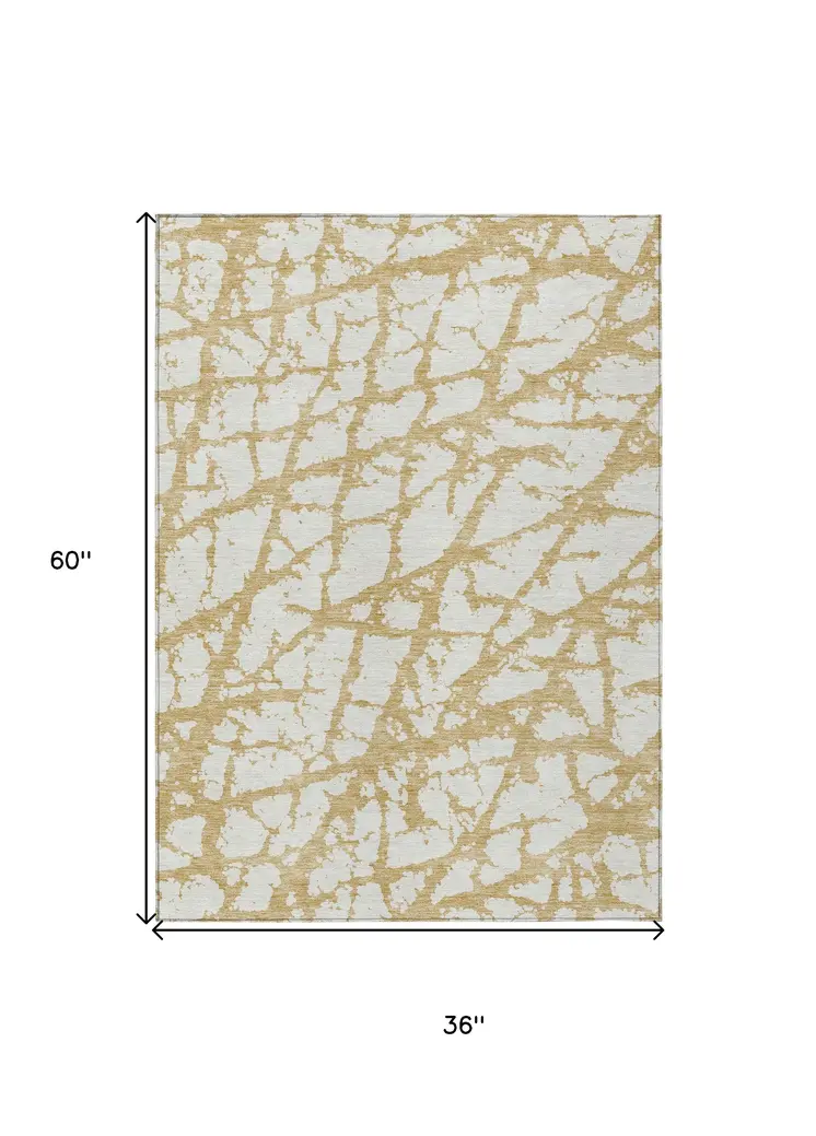 3' X 5' Gold And Ivory Abstract Washable Indoor Outdoor Area Rug