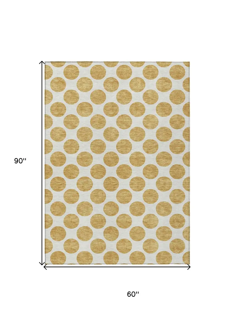 5' X 8' Gold And Ivory Polka Dot Washable Indoor Outdoor Area Rug