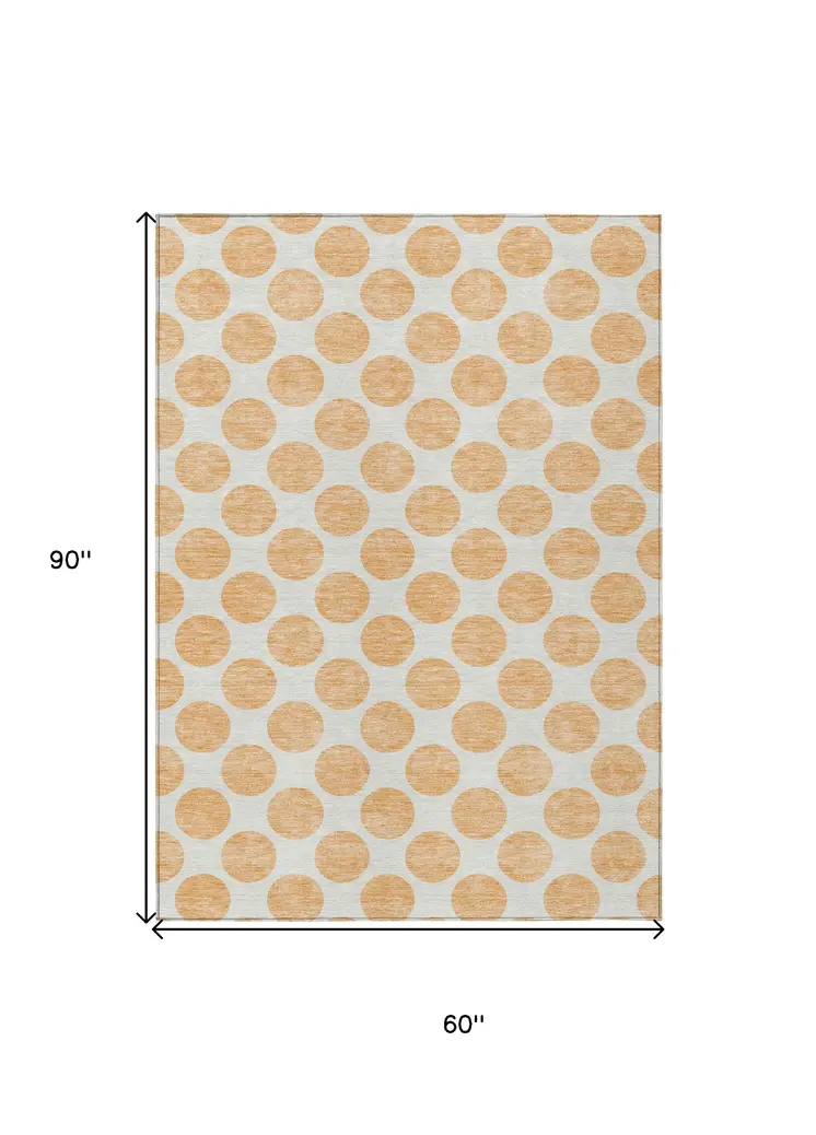 5' X 8' Peach And Ivory Polka Dot Washable Indoor Outdoor Area Rug